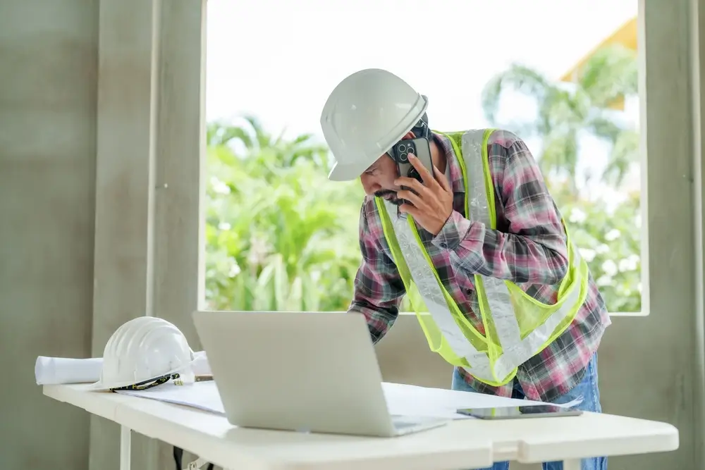 Construction worker using wearable safety technology on connected jobsite in 2025.